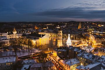Fototapeta na wymiar Beautiful aerial view of decorated and illuminated Christmas tree on the Cathedral Square at night in Vilnius, Lithuania.