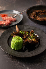 Lamb ribs with green rice. Stewed meat.