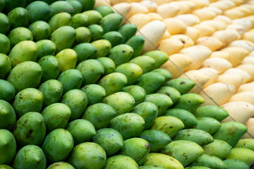 Freshness green and yellow mango arrange neatly on the fruit stall in supermarket