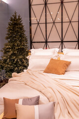 Pastel purple and beige bedding - soft pillows and fur coverlet. coziness, comfort, interior and christmas holidays concept