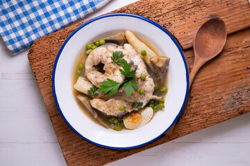 Conger eel with white asparagus and egg. Traditional Spanish tapas from a fishing village.