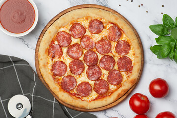 Pepperoni pizza on wooden board on gray background