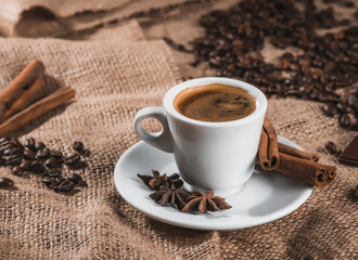 Espresso and chocolate slices on a brown background of burlap