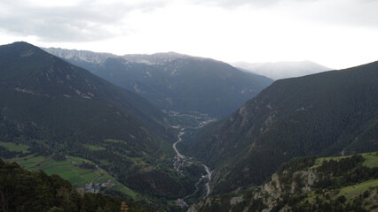 Obraz premium View on a road between the mountains. Natural view of green hills and car roads