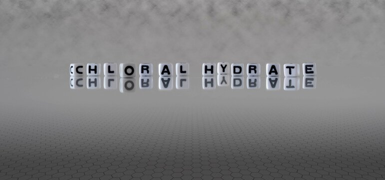 chloral hydrate word or concept represented by black and white letter cubes on a grey horizon background stretching to infinity