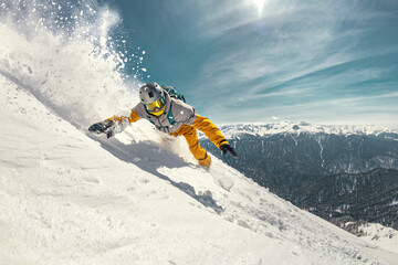 Real professional snowboarder rides at off-piste ski slope. Winter sports concept - obrazy, fototapety, plakaty