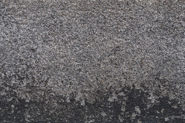 Old gray concrete surface with dirty smudges, grungy vintage background close up, grunge texture