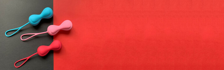 Banner. Sex toys for woman. Jiggle balls on a red and black background. Three ben wa balls of silicone. Useful for sex shop