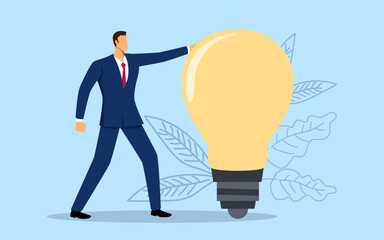 Businessman holding a giant light bulb