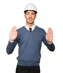 Serious young architect making a gesture of prohibition with his hand