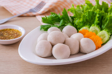 Boiled fish balls and vegetable on white plate