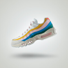 White sneaker with a diversity of colors, shoe on a white gradient background, Yellow, pink, blue, green, men's / woman's fashion, sport shoe, air, sneakers, lifestyle, concept, product photo,