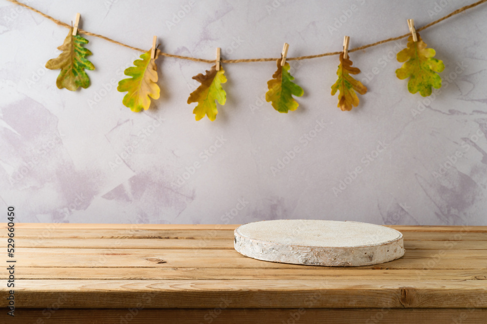 Canvas Prints Empty wooden log on table over autumn leaves garland background. Thanksgiving holiday kitchen mock up for design and product display