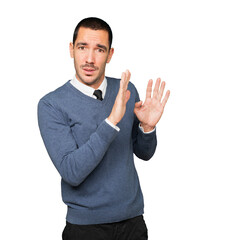 Scared young man screaming against background