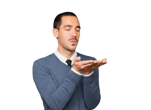 Friendly young man making a gesture of sending a kiss with his hand