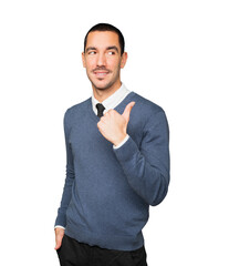 Happy young man pointing with his thumb