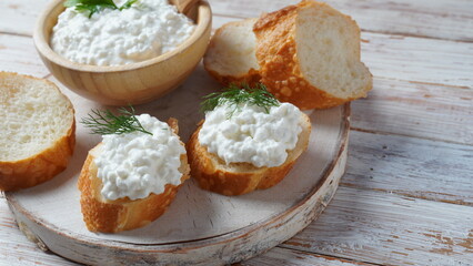 Cottage cheese in a bowl  on a wooden background. Diet and healthy eating concept