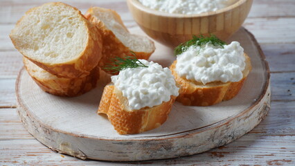 Cottage cheese in a bowl  on a wooden background. Diet and healthy eating concept