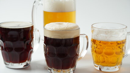Mugs of beer different flavor - light, dark, and red