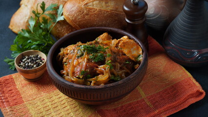 Chakhokhbili - traditional Georgian dish. Chicken stewed with fresh coriander tomatoes and herbs