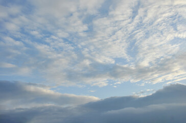 beautiful white clouds and blue sky in higher atmosphere and dark grey clouds in lower atmosphere...