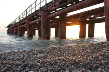an abandoned marina in the sea. iron pier