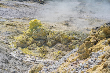 smoking solfatara in a fumarole field on the slope of the Mendeleev volcano
