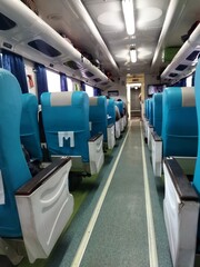 the rows of passenger seats of the train that look neat and clean