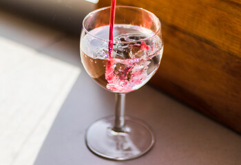 Shot of a red liquid being poured in to the wine glass. Concept