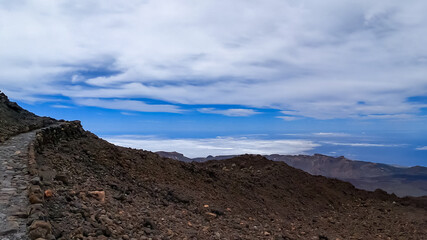 Well maintained hiking trail over volcanic desert terrain leading to summit of volcano Pico del...