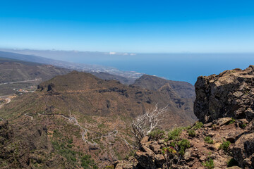 Fototapeta na wymiar Scenic view on the mountain road leading to Masca village in the Teno mountain massif, Tenerife, Canary Islands, Spain, Europe. Seen from summit Pico Verde with Atlantic Ocean view. Tropical climate
