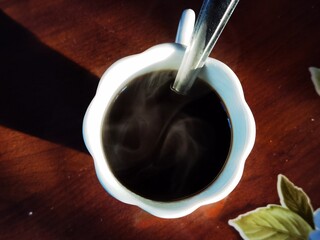 cup of steaming black coffee in an Italian restaurant in western Liguria