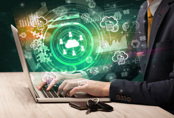 Business hand typing on a modern laptop