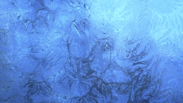 Abstract frosty pattern on glass, background texture on the window