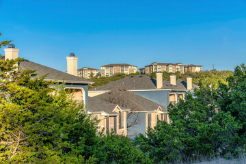 Fototapeta na wymiar New Construction in Lake Austin of houses with clear blue sky and scenic views