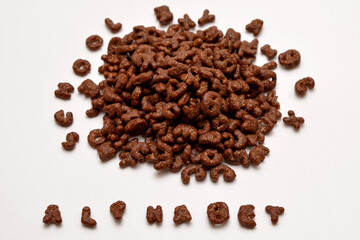 ready breakfast chocolate flakes in the form of alphabet letters on a white background