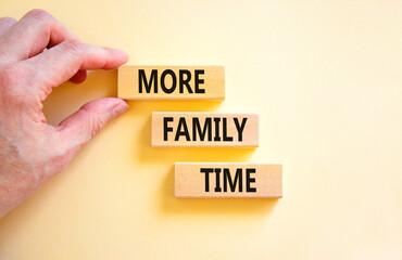 More family time and support symbol. Concept words More family time on wooden blocks. Businessman hand. Beautiful white table white background. Business, more family time qoute concept. Copy space.