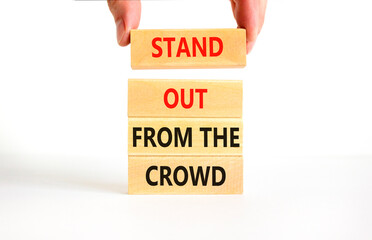 Stand out from the crowd symbol. Concept words Stand out from the crowd on wooden blocks on...