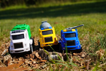 Young child's toy truck set sitting outside.