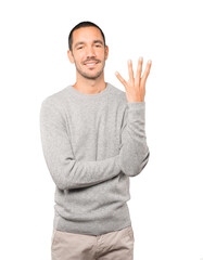 Young man making a number four gesture