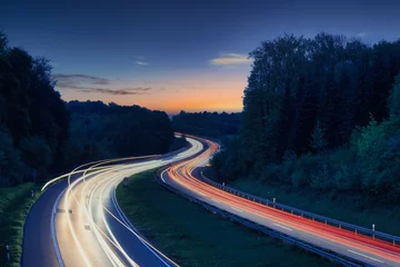 Fototapeten long exposure by night german highway car lights with beatiful sky © Peter