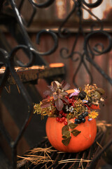 Pumpkin with flowers on a cast-iron staircase