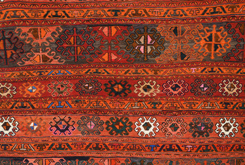 The texture of a piece of old carpet in the Turkish style.
