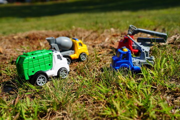 Young child's toy truck set sitting outside.