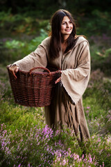 Young woman in fairy tale with wicker basket
