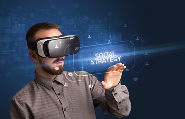Businessman looking through Virtual Reality glasses, social media concept