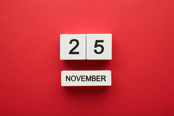 Wooden calendar 2022 with inscription 25 november on red background. Black friday