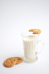A glass of milk with delicious cookies