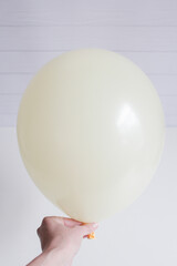 beige latex balloon isolated on white background