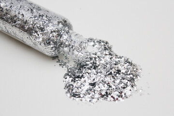 silver glitter confetti on white background